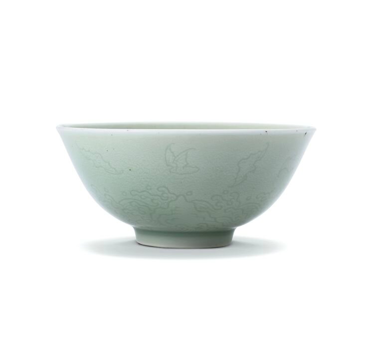 A celadon-glazed incised 'bats and waves' bowl, Mark and period of Yongzheng