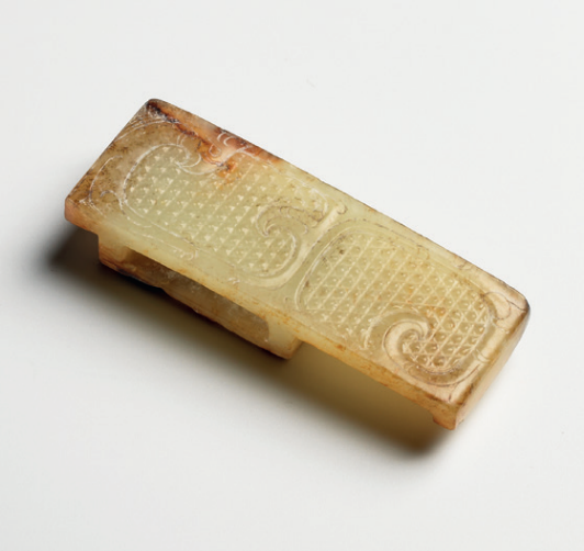 A white and russet jade patterned scabbard slide, Warring States period (475-221 BC)