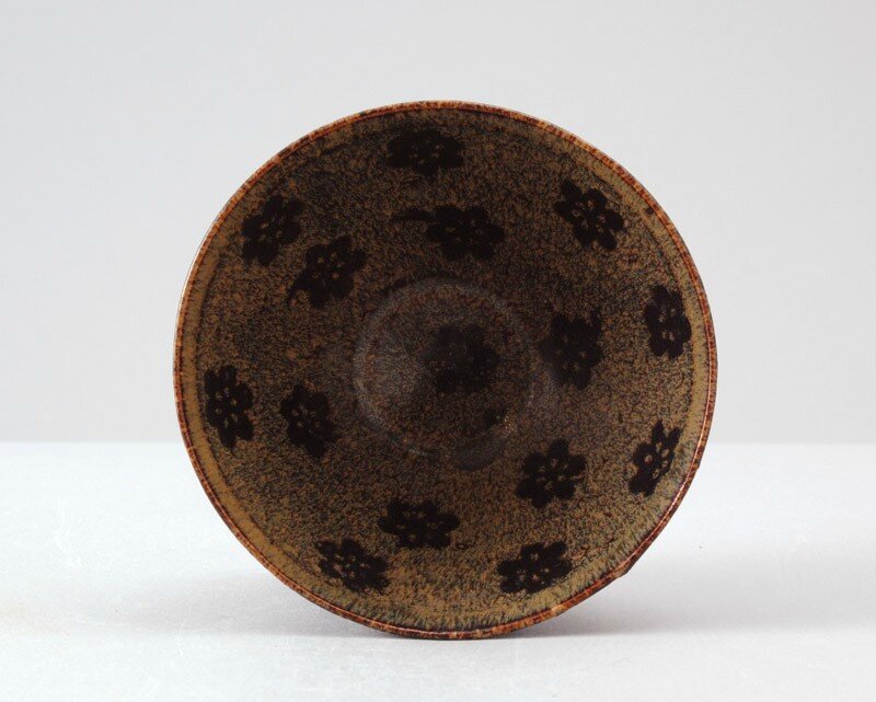 Black ware tea bowl with plum blossom decoration, Jizhou kiln-sites, 12th - 13th century, Southern Song Dynasty (1127 - 1279)