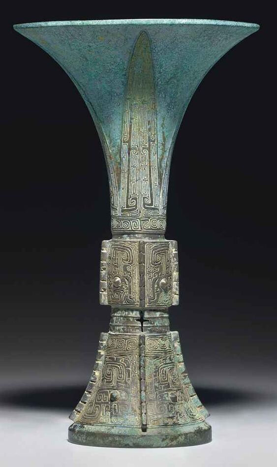 A bronze tripod ritual wine vessel, gu, Shang dynasty, 13th-12th century BC