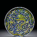 An underglaze-blue and yellow-enamelled 'Dragon' dish, Kangxi six-character mark within double circles and of the period (1662-1722)