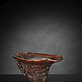 a fine carved brown rhinoceros wine cup with taotie masks