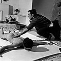 Yves klein in his studio, directing a model in body art painting (1961) 
