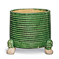 A small green and yellow-glazed cylindrical tripod censer, Tang dynasty (AD 618-907)