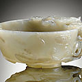 A carved pale green jade peach-form libation cup, ming dynasty, 17th century