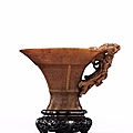 A finely carved 'Mythical Beasts' rhinoceros horn libation cup, Ming dynasty, early 17th century