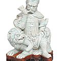 A rare celadon figurine 'guardian on a fô-dog'. china, around 1800 (qing-dynasty 1644-1911)