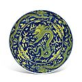 A blue-ground yellow-enamelled 'dragon' dish, qianlong six-character seal mark in underglaze blue and of the period (1736-1795)