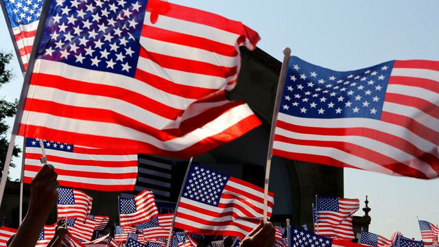 people-wave-flags-for-u-s-republican-presidential-candidate-romney-at-a-campaign-rally-in-le-claire-park-bandshell-in-davenport_5172793