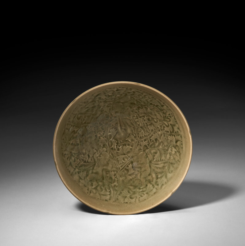 A molded and carved Yaozhou celadon 'boys' bowl, Northern Song dynasty (960-1127)