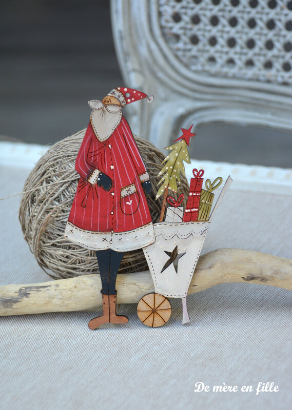 grand père noel et sa brouette de cadeaux