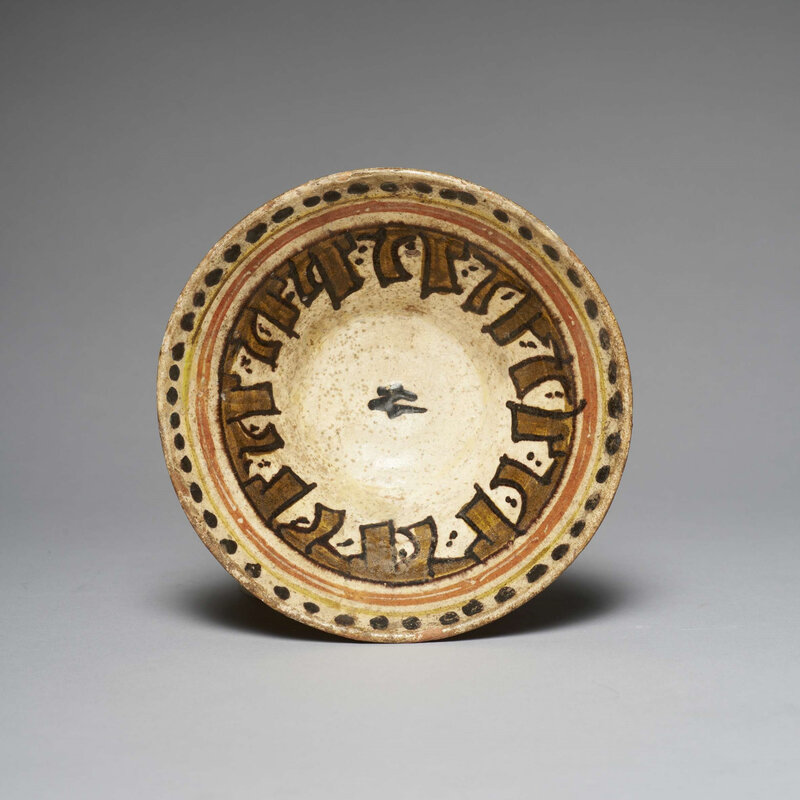 A Samanid slip-painted pottery cup with inscriptions, 10th-11th century
