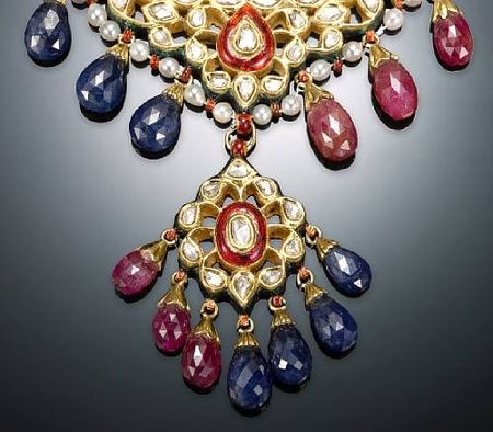 A yellow gold necklace with rubies, sapphires, pearls, diamonds, and ...
